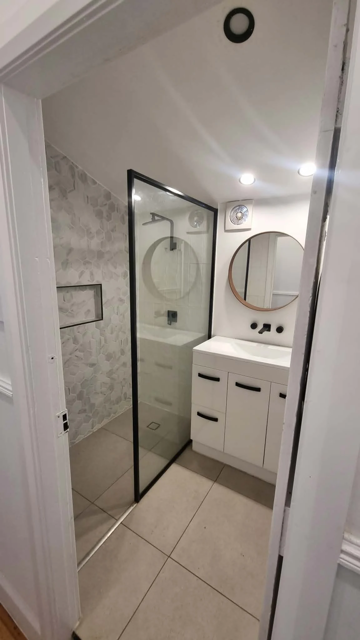 Completed bathroom with black framed details